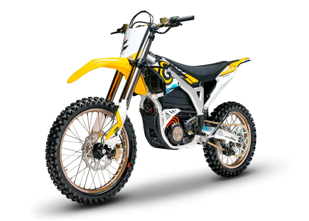 Sur-Ron Storm Bee Sur Ron Storm Bee electric dirt bike in motion on a forest trail, rider leaning into a turn, dust kicking up. Dynamic off-road action shot.